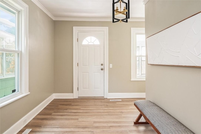 69 Diem St, Rochester, NY 14620 - foyer featuring a chandelier, light wood-style flooring, and crown molding