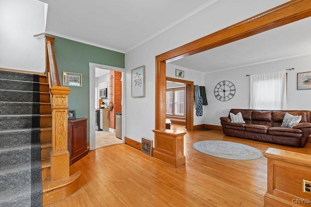 133 Bryant Ave, Syracuse, NY 13204 - living room featuring light wood finished floors, ornamental molding, plenty of natural light, and stairs