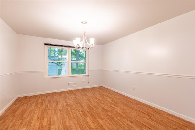 10 Chesfield Lookout, Perinton, NY 14450 - unfurnished room with a chandelier and light wood-type flooring