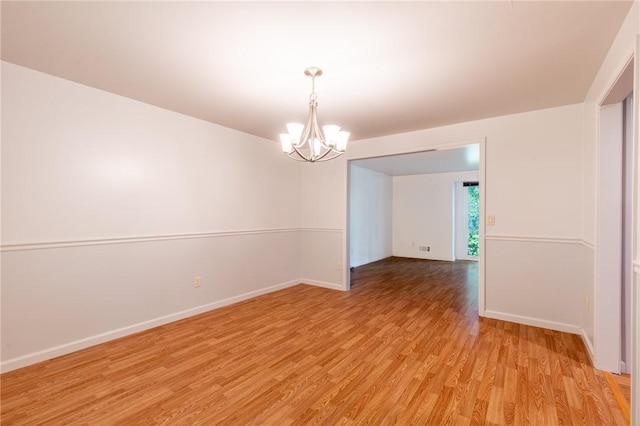 10 Chesfield Lookout, Perinton, NY 14450 - empty room with a chandelier and light wood finished floors