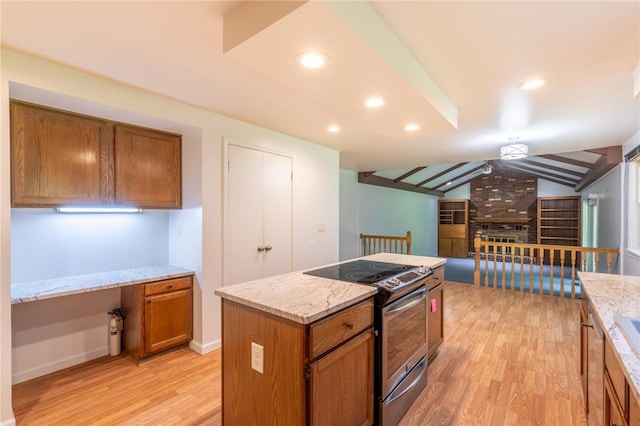 10 Chesfield Lookout, Perinton, NY 14450 - kitchen featuring stainless steel electric range oven, light wood-style floors, brown cabinets, built in desk, and lofted ceiling