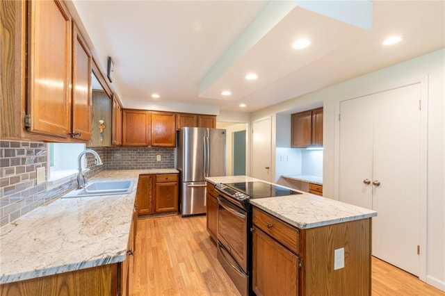 10 Chesfield Lookout, Perinton, NY 14450 - kitchen with appliances with stainless steel finishes, brown cabinets, light wood-style floors, a center island, and backsplash