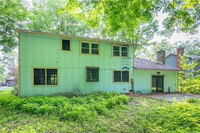 10 Chesfield Lookout, Perinton, NY 14450 - back of house featuring board and batten siding and a chimney