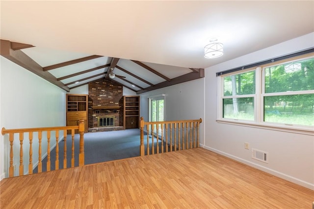 10 Chesfield Lookout, Perinton, NY 14450 - spare room featuring ceiling fan, wood finished floors, and a brick fireplace