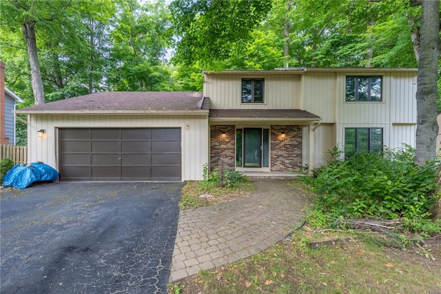 10 Chesfield Lookout, Perinton, NY 14450 - view of front facade with asphalt driveway, a garage, and brick siding