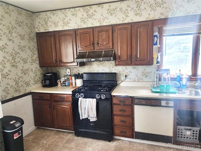 914 S Main St, Shelby, NY 14103 - kitchen with black gas range oven, white dishwasher, under cabinet range hood, wallpapered walls, and light countertops