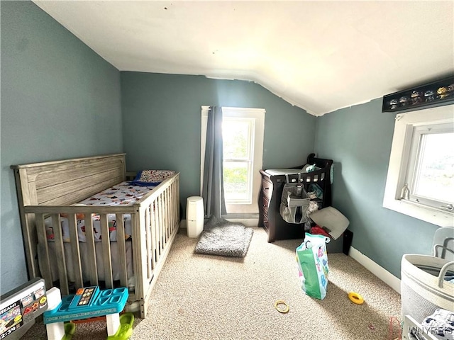 914 S Main St, Shelby, NY 14103 - bedroom with lofted ceiling, carpet floors, multiple windows, and a crib