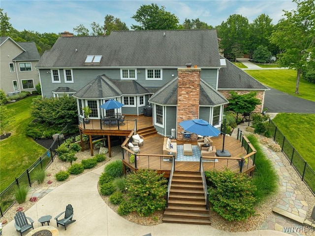 135 Fox Meadow Ln, Orchard Park, NY 14127 - back of property with a deck, a fenced backyard, outdoor dining space, and a chimney