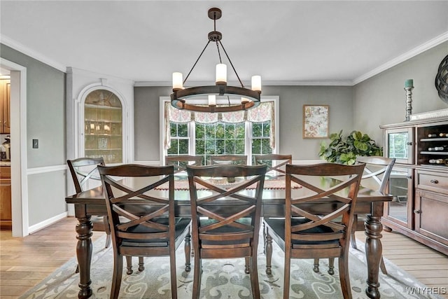 135 Fox Meadow Ln, Orchard Park, NY 14127 - dining space with light wood-style flooring, plenty of natural light, crown molding, and a chandelier