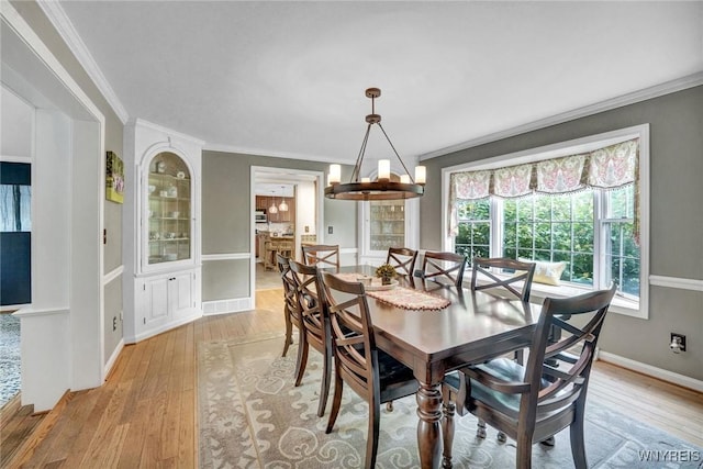 135 Fox Meadow Ln, Orchard Park, NY 14127 - dining room featuring light wood-type flooring and crown molding