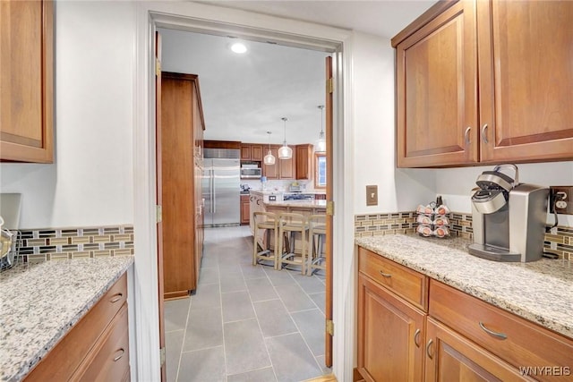 135 Fox Meadow Ln, Orchard Park, NY 14127 - kitchen with appliances with stainless steel finishes, backsplash, brown cabinets, tile patterned floors, and recessed lighting