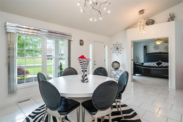 8 Brongo Ln, Gates, NY 14559 - dining area featuring a chandelier, vaulted ceiling, healthy amount of natural light, and light tile patterned floors
