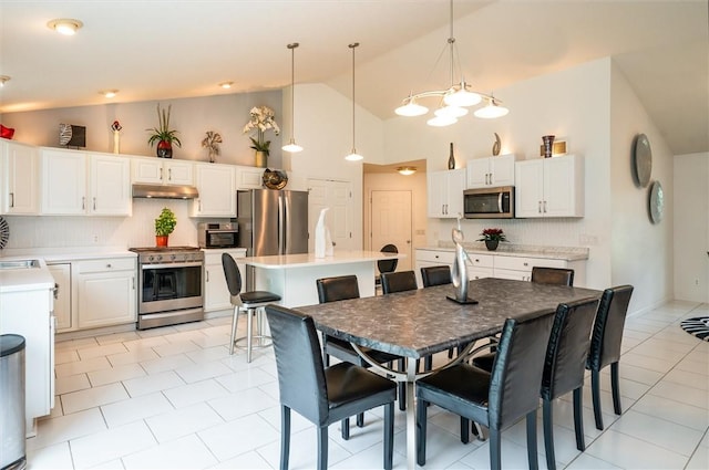 8 Brongo Ln, Gates, NY 14559 - dining space featuring high vaulted ceiling and light tile patterned floors