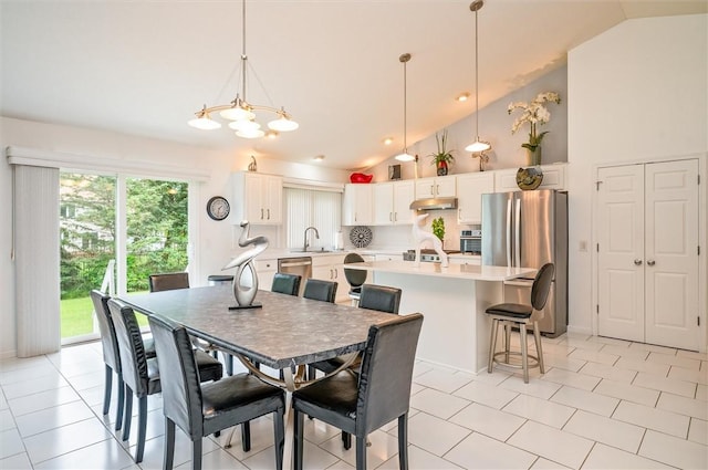 8 Brongo Ln, Gates, NY 14559 - dining space with vaulted ceiling, a chandelier, and light tile patterned floors