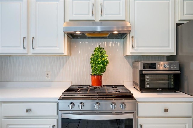 8 Brongo Ln, Gates, NY 14559 - kitchen with stainless steel gas stove, under cabinet range hood, white cabinets, and light countertops