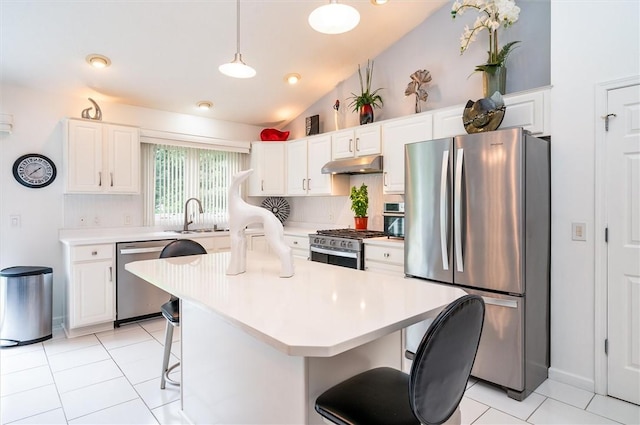 8 Brongo Ln, Gates, NY 14559 - kitchen featuring appliances with stainless steel finishes, under cabinet range hood, vaulted ceiling, a kitchen breakfast bar, and light countertops