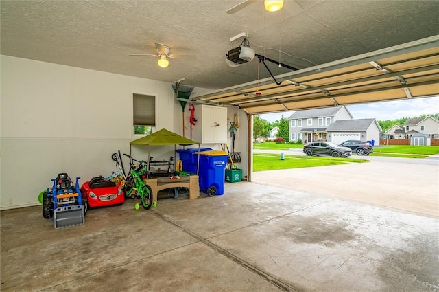 8 Brongo Ln, Gates, NY 14559 - garage featuring a garage door opener, a ceiling fan, and a residential view