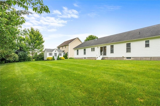 8 Brongo Ln, Gates, NY 14559 - rear view of house featuring a lawn and entry steps