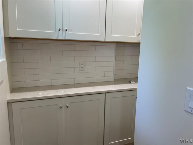 203 E Genesee St, Manlius, NY 13066 - kitchen with white cabinets, backsplash, and light stone countertops