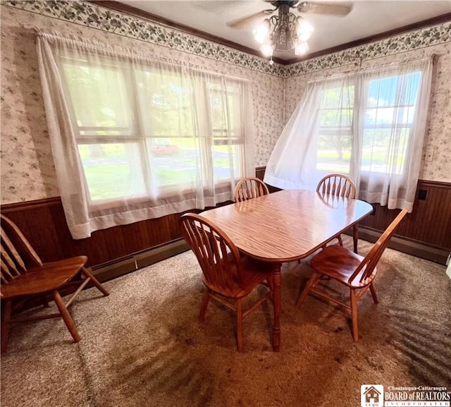 3194 Cranberry Rd, Allegany, NY 14760 - dining area with wallpapered walls, wainscoting, a ceiling fan, a baseboard radiator, and carpet floors