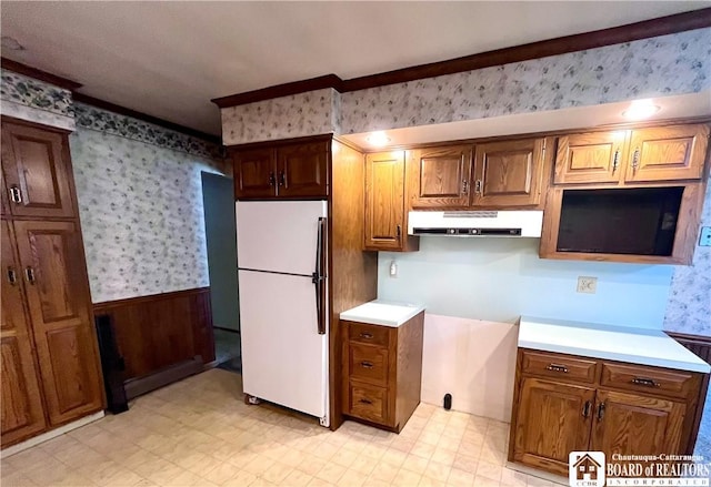 3194 Cranberry Rd, Allegany, NY 14760 - kitchen with freestanding refrigerator, range hood, wallpapered walls, wainscoting, and light countertops