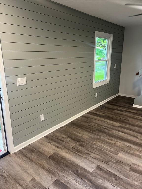 45 Falcon Ln E, Perinton, NY 14450 - unfurnished room featuring dark wood-style flooring and wooden walls