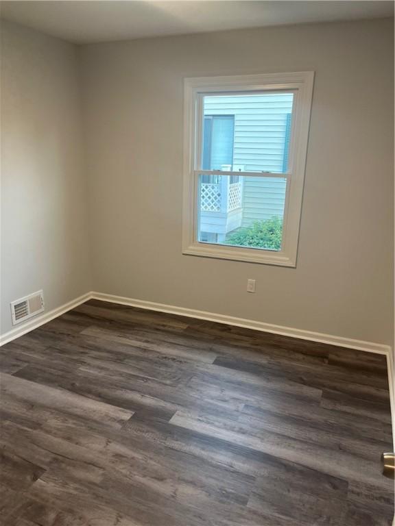 45 Falcon Ln E, Perinton, NY 14450 - empty room featuring dark wood-style flooring and baseboards
