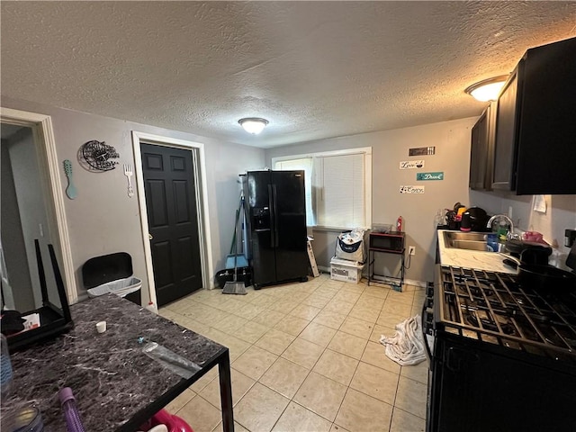 505 Child St, Rochester, NY 14606 - kitchen featuring range with gas cooktop, black fridge with ice dispenser, a textured ceiling, and light tile patterned flooring
