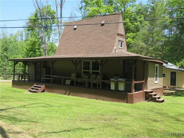 8211 Elmwood Dr, Rushford, NY 14717 - back of property featuring a shingled roof, a yard, and a gambrel roof