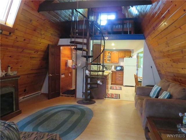 8211 Elmwood Dr, Rushford, NY 14717 - living area featuring stairway, wooden walls, light wood-style flooring, and vaulted ceiling