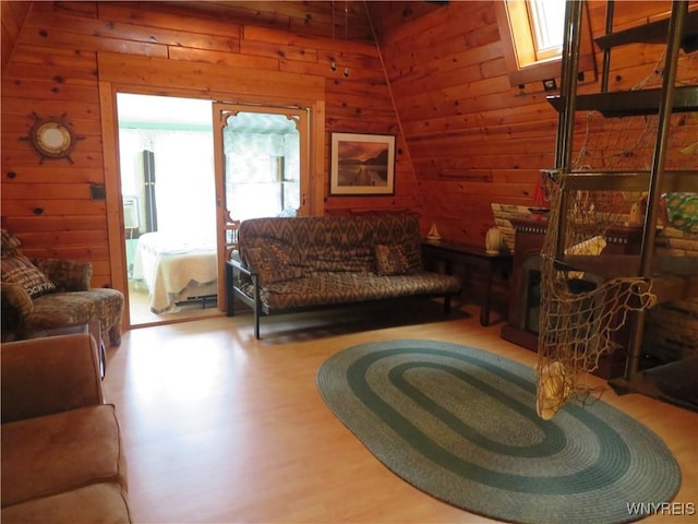 8211 Elmwood Dr, Rushford, NY 14717 - living area featuring wooden walls, healthy amount of natural light, and wood finished floors