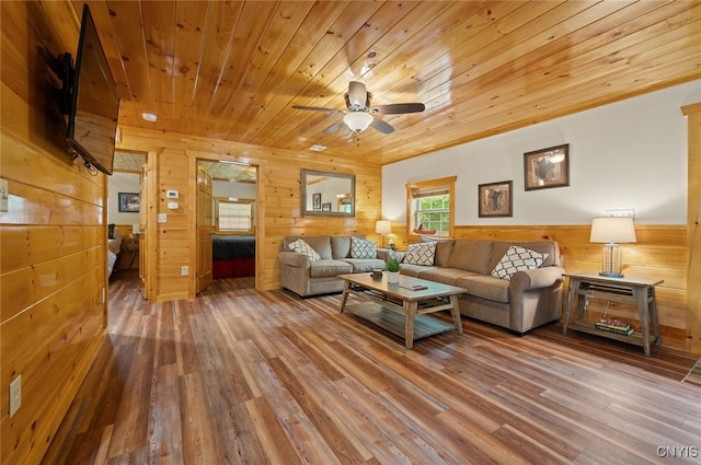 224 Macarthur Rd, Russia, NY 13324 - living room with wooden walls, wood finished floors, wood ceiling, ceiling fan, and wainscoting