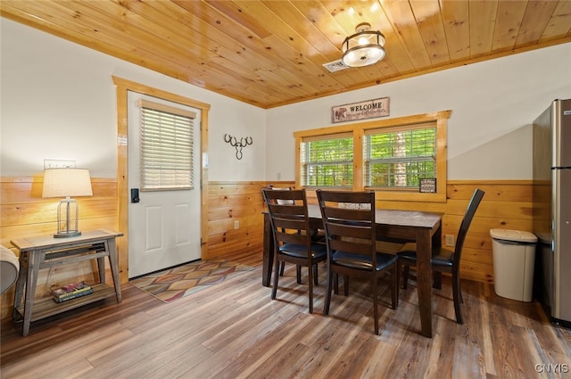224 Macarthur Rd, Russia, NY 13324 - dining room with wainscoting, wood ceiling, wood finished floors, and wooden walls