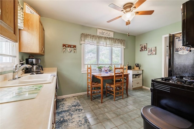 167 Cheltenham Rd, Rochester, NY 14612 - kitchen with a ceiling fan, black range with gas stovetop, light countertops, and light tile patterned flooring
