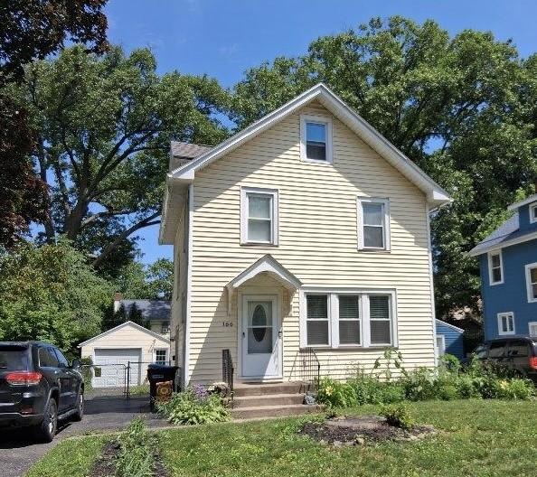166 Burwell Rd, Irondequoit, NY 14617 - view of front of house with a detached garage, a chimney, and an outbuilding