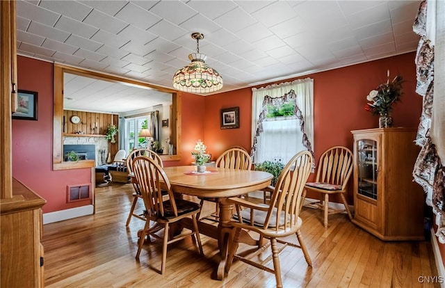 6954 Rome Oriskany Rd, Rome, NY 13440 - dining room with a fireplace, plenty of natural light, and light wood-style floors
