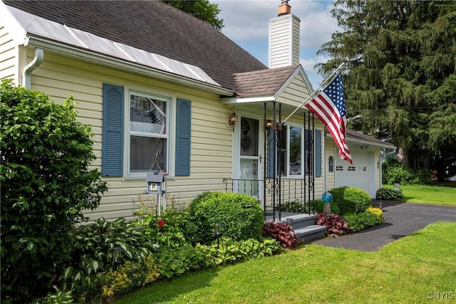 6954 Rome Oriskany Rd, Rome, NY 13440 - view of front of home featuring a chimney, an attached garage, and a front lawn