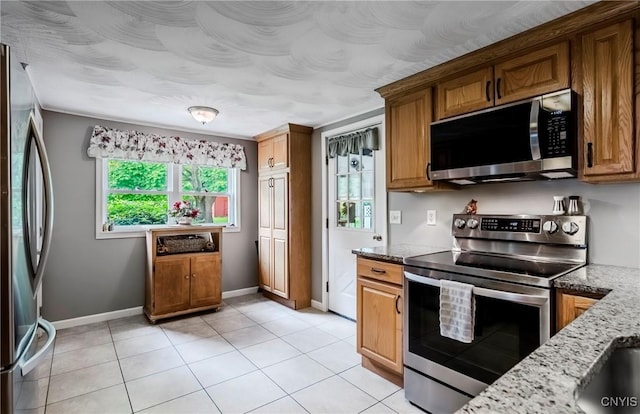 6954 Rome Oriskany Rd, Rome, NY 13440 - kitchen featuring stainless steel appliances, light stone countertops, brown cabinets, and light tile patterned floors