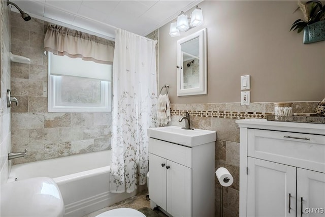 6954 Rome Oriskany Rd, Rome, NY 13440 - bathroom with vanity, tile walls, shower / bath combo with shower curtain, and a wainscoted wall