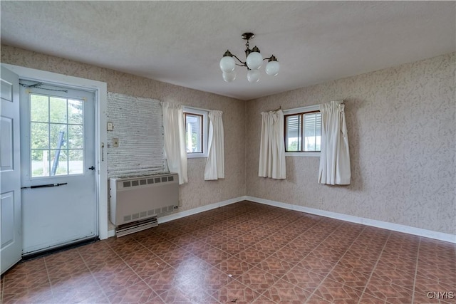 12324 US Route 11, Adams, NY 13606 - unfurnished dining area featuring radiator heating unit, a chandelier, and dark flooring