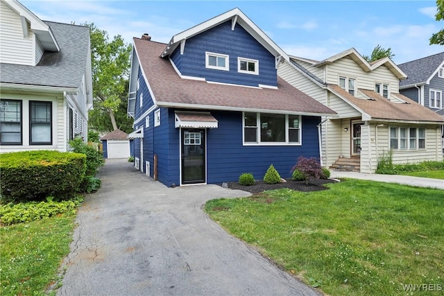 42 Frontenac Ave, Buffalo, NY 14216 - view of front of house featuring an outdoor structure, a front lawn, a shingled roof, and a detached garage