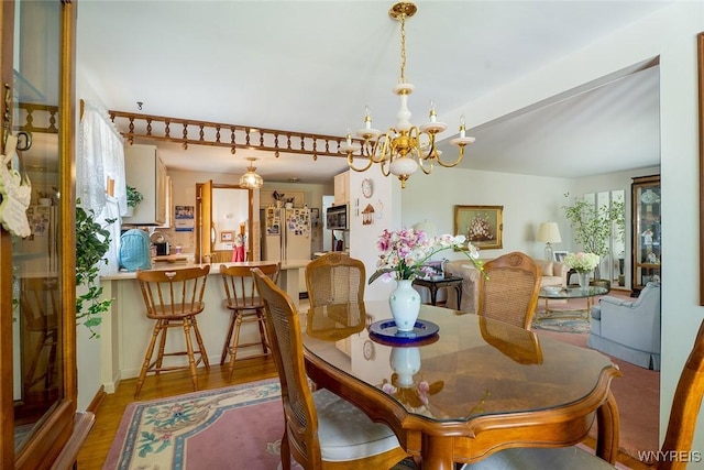 174 Homewood Ave, Tonawanda, NY 14217 - dining area featuring a chandelier and light wood-style floors
