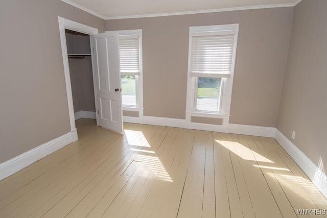 45 S Academy St, Middlebury, NY 14591 - unfurnished bedroom featuring light wood-style floors, multiple windows, ornamental molding, and a closet
