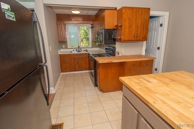 45 S Academy St, Middlebury, NY 14591 - kitchen with black appliances, butcher block counters, brown cabinetry, and light tile patterned flooring