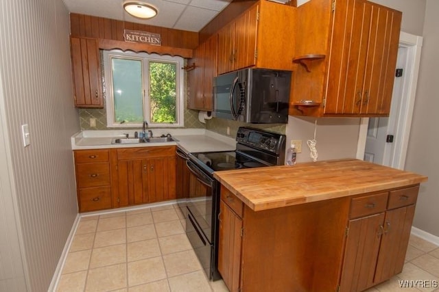 45 S Academy St, Middlebury, NY 14591 - kitchen featuring black appliances, brown cabinetry, light tile patterned floors, and backsplash