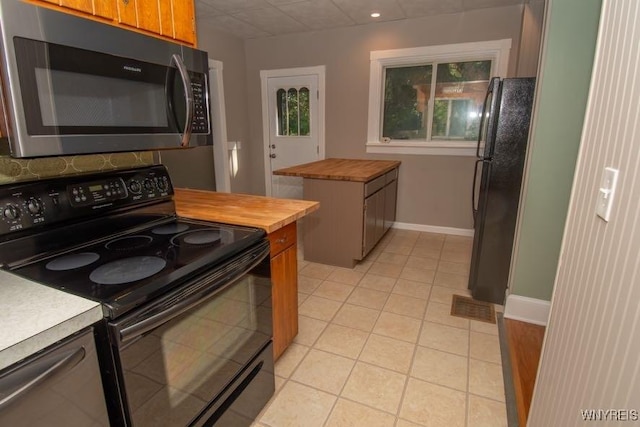 45 S Academy St, Middlebury, NY 14591 - kitchen featuring black appliances, wooden counters, light tile patterned flooring, brown cabinets, and tasteful backsplash
