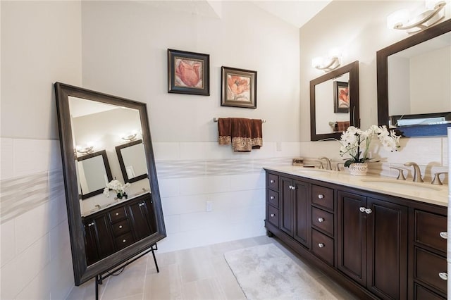31 Spruce Rdg, Perinton, NY 14450 - full bathroom with tile walls, double vanity, wainscoting, and lofted ceiling