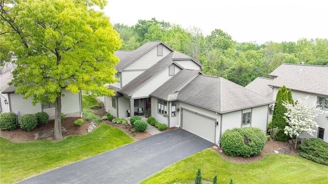 31 Spruce Rdg, Perinton, NY 14450 - view of front of property with asphalt driveway, a garage, a front yard, and roof with shingles