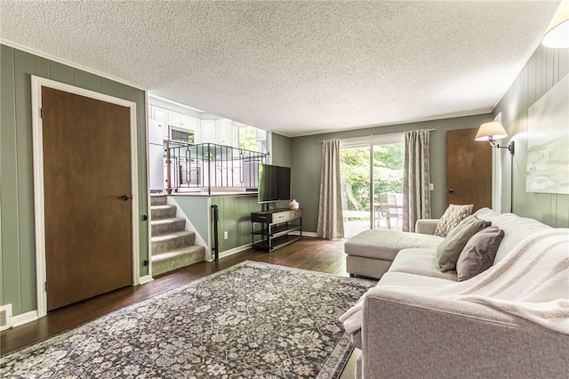 218 Fox Hall Dr, Irondequoit, NY 14609 - living room with dark wood-style flooring, stairs, ornamental molding, and a textured ceiling