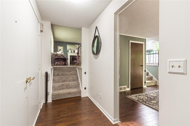 218 Fox Hall Dr, Irondequoit, NY 14609 - corridor featuring stairway, wood finished floors, and a textured ceiling
